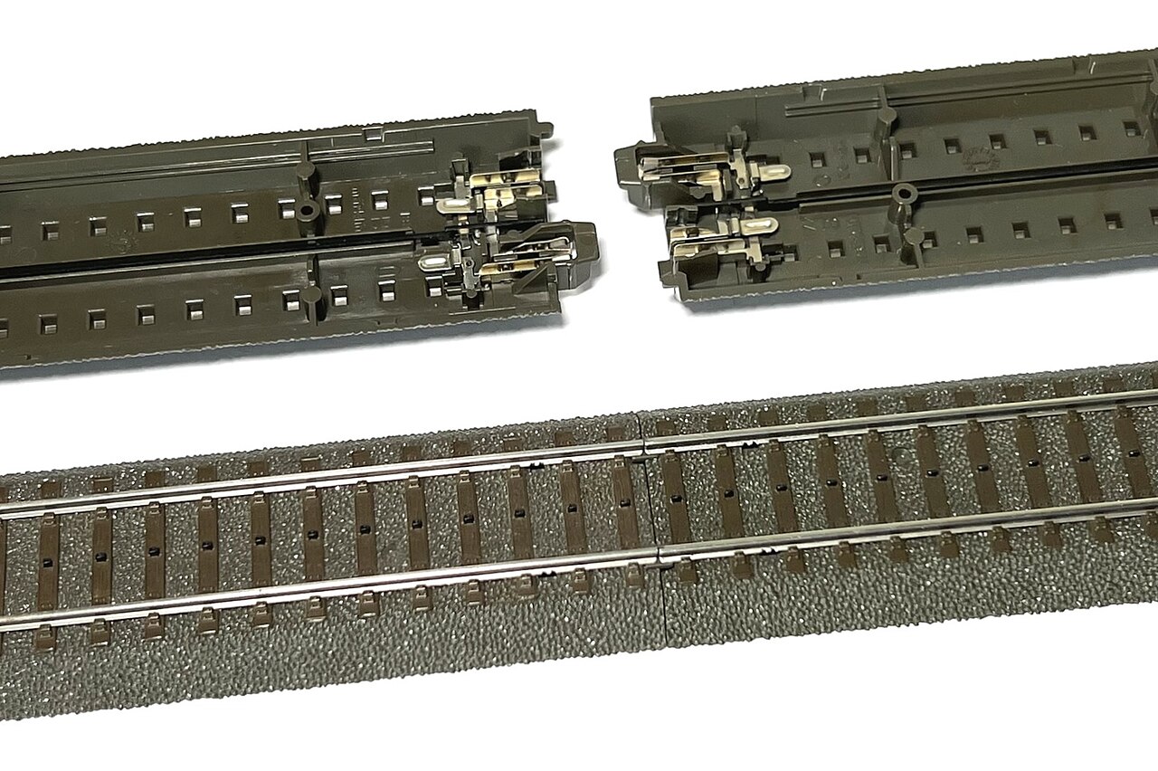 Märklin C-track roadbed seen from below, two sections apart with metal connectors at the ends, and a joined section from above